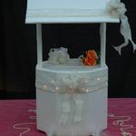 Ivory Lighted Wishing Well: Satin glitter fabric. Ivory gold ribbon & bow circles the well & roof, softly illuminated by lights behind the ribbon. Ivory gold bow accents cover of well, trimmed with pearls.  A gentle spotlight illuminates the bow. Romantic; suitable for large weddings.