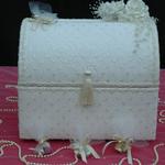Ivory Treasure Chest is covered in elegant ivory silk fabric trimmed with pearls & iridescent sequins.  The edges are adorned with ivory pearl swirls. Ivory flowers with pearl trim or ivory roses accent the box. The color of the flower accessories can be changed to match or compliment wedding colors
