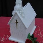 White Church has an organza fabric covered with an eyelet organza. Pearls adorn the base of the church and white flowers stream from the front of the steeple. An elegant cross in gold or silver hangs on the front of the church. Great for small weddings or bridal showers.