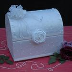 White Treasure Chest is covered in white satin with embroidered leaves. The top edge is trimmed with white bows and rhinestones, white satin ribbon trims the bottom of the lid & bottom of the chest. The color of the bows & flower accessories can also be changed to match or compliment wedding colors.